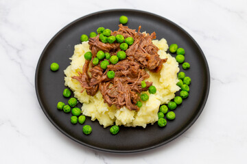 Butterflied beef with mashed potatoe and peas