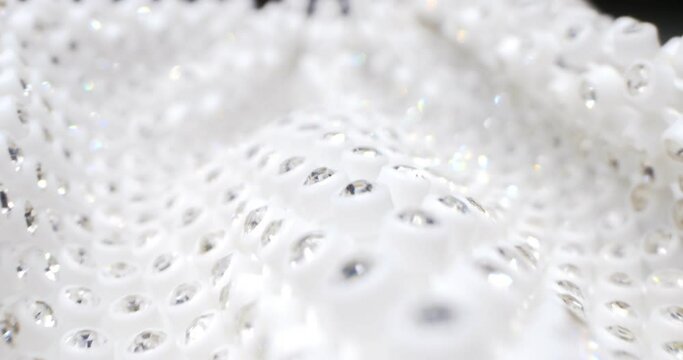 detailed extreme close-up silver rhinestones on white fabric