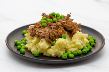 Butterflied beef with mashed potatoe and peas