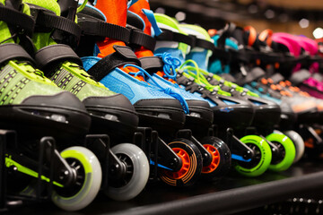 Photo of various colored roller skates standing on sport store shelf.