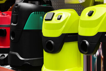 Photo of various industrial vacuum cleaners standing on construction supply store shelf.