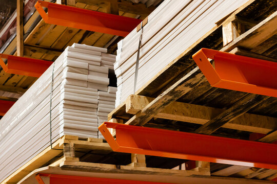 Photo of plywood panels stacked in construction supply store shelves.