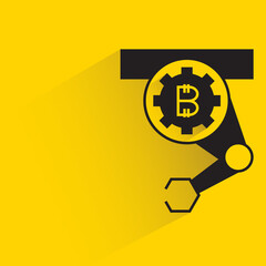 robotic arm with bitcoin icon shadow on yellow background