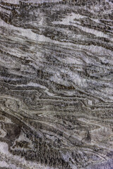 Abstract gray texture of natural, raw salt in an underground salt mine