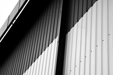 Details of black and white corrugated iron sheet used as a facade of a warehouse or factory....