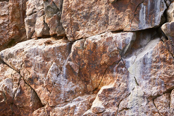 Relief and texture of red stone with patterns. Stone natural background.
