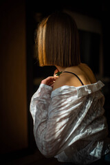 Beauty portrait of a beautiful young girl with a shadow pattern on the face and body in the form of...