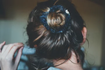 Fotobehang Back view of a comfortly bun hairstyle of a young woman © nanihta