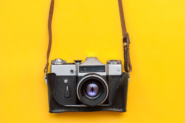 Retro film camera on yellow background