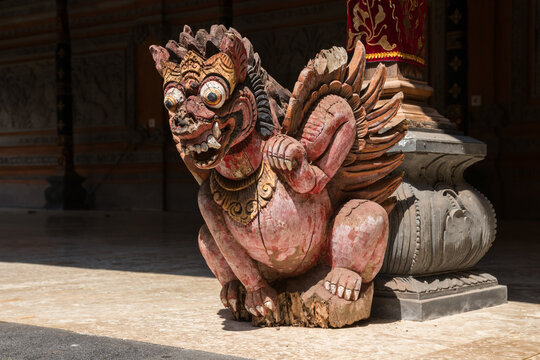 Old, painted, wooden statue at the hindu Puri Kantor temple, Ubud, Bali, Indonesia.