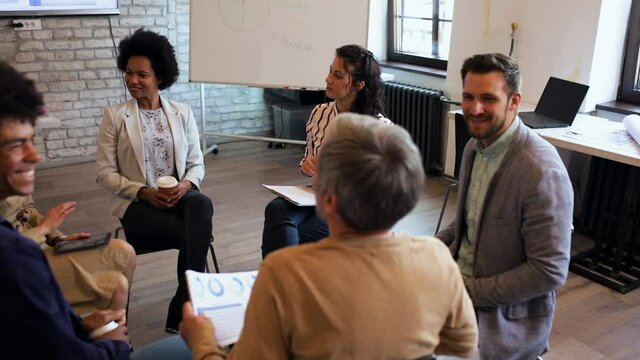 Diverse group of business people having a meeting while sitting in circle.