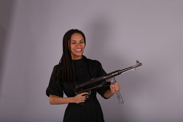Pretty curly woman with vintage german submachine gun