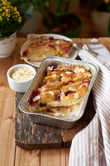 Bread pudding with raspberry. Side view, wooden background.