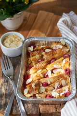Bread pudding with raspberry. Side view, wooden background.