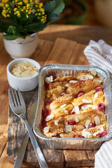 Bread pudding with raspberry. Side view, wooden background.