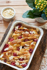 Bread pudding with raspberry. Side view, wooden background.