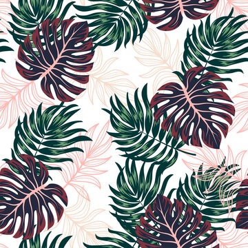 Seamless tropical pattern with bright colorful plants and leaves on a white background. Jungle leaf seamless vector floral pattern background. Seamless exotic pattern with tropical plants.