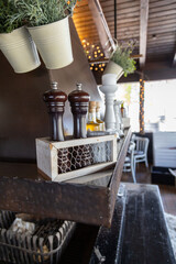 Restaurant interior, fireplace in the restaurant, salt and pepper shaker .