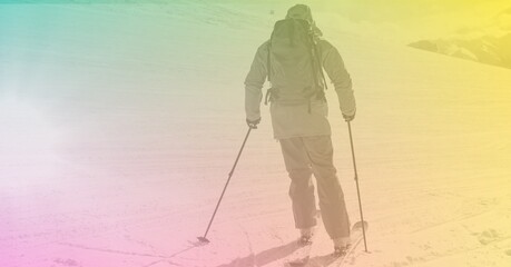Composition of skier skiing down in mountains with green to yellow tint