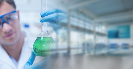 Composition of caucasian male scientist holding beaker in laboratory with copy space