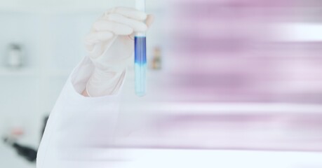 Composition of scientist holding test tube with blue liquid working in laboratory and copy space