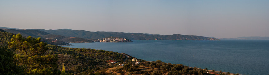 Naklejka na ściany i meble Panorama of Harbour in Singitic Gulf in Aegean Sea with Pyrgadikia Village on Hill Bushes and Trees in Sunset Light - Sea Landscape Sight from Mountain on Sithonia Chalkidiki Greece