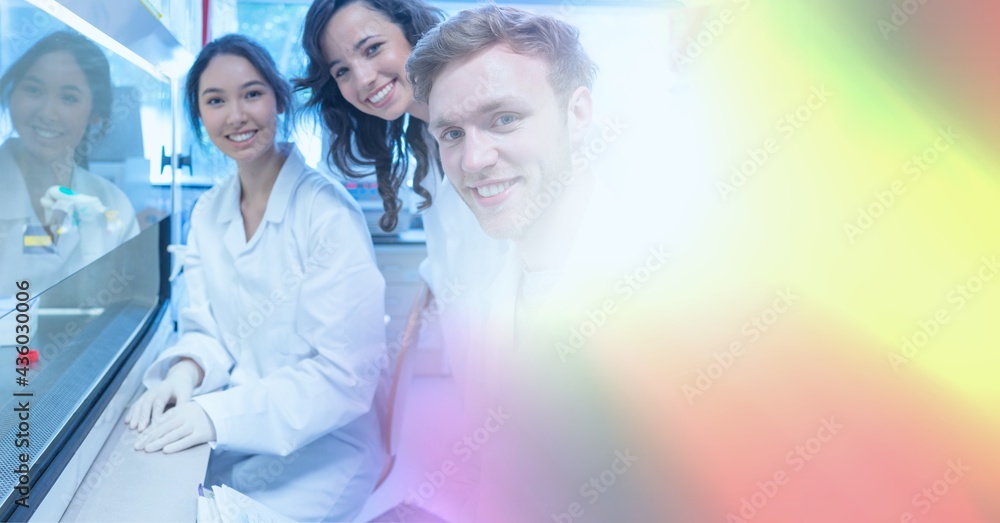 Poster composition of smiling lab technicians using at work, with blurred colourful copy space to right