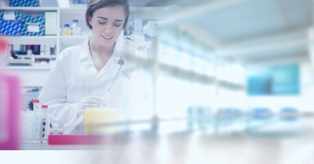Composition of smiling female lab technician at work, with yellow blurred copy space to right