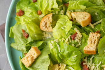 Caesar salad with croutons and bacon.