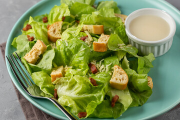 Caesar salad with croutons and bacon.