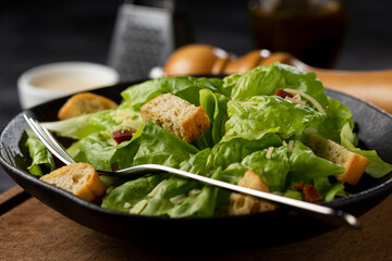 Caesar salad with croutons and bacon.