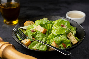 Caesar salad with croutons and bacon.