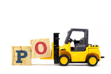 Toy forklift hold letter block O to complete word PO (Abbreviation of purchase order) on wood background