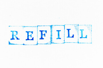 Blue color ink rubber stamp in word refill on white paper background