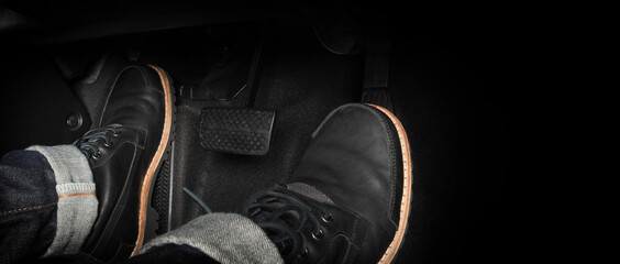 Foot pressing foot pedal of a car to drive. Accelerator and brake pedal in a car. Driver driving...