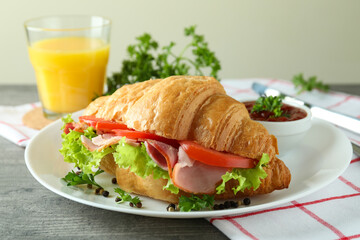 Concept of tasty eating with croissant sandwich, close up