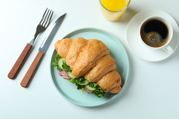 Concept of tasty eating with croissant sandwich on white background