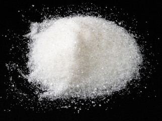 Obraz na płótnie Canvas pile of white sugar from sugar beet on black