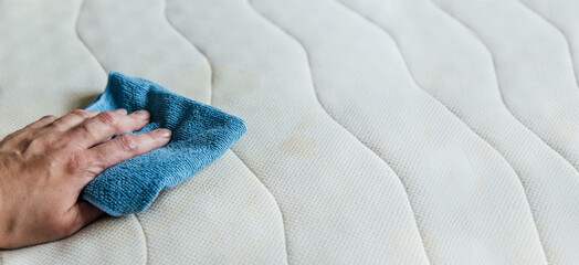 wipe the mattress with a rag, cleaning the mattress 