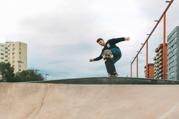 boy skating with a snake board in a skate park