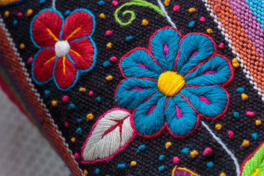 Peruvian crafts: Embroidered flower ornaments on a handmade fabric
