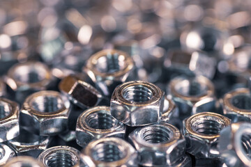 Metal chrome nuts in a chaotic order industrial background