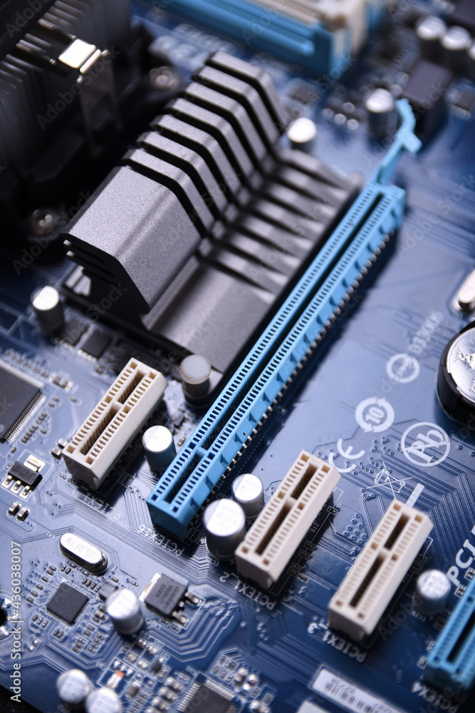  computer fan on motherboard and electronical components cpu gpu memory and different sockets for vid