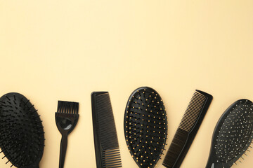 Hair tools, beauty and hairdressing concept - different brushes or combs on beige background....