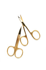 Small gold manicure scissors isolated on white background