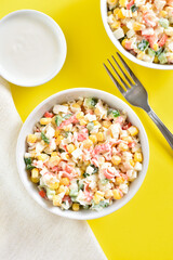 Salad with crab sticks, corn, eggs, cucumber and rice