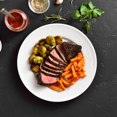 Grilled beef steak with brussels sprouts and sweet potatoes