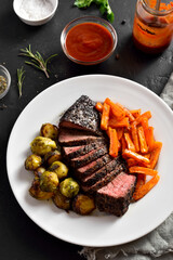 Grilled beef steak with brussels sprouts and sweet potatoes