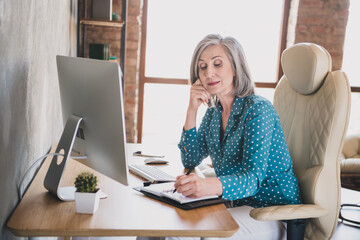 Profile side photo of elderly business woman sit office desk concentrated write notebook plan to-do...