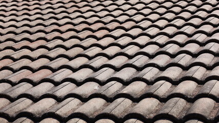 Close-up of old tiled roof on a sunny day. Selective focus